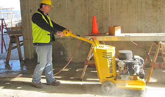 concrete-grinder-removing-glue